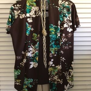 Brown pleasing print flutter sleeved blouse.